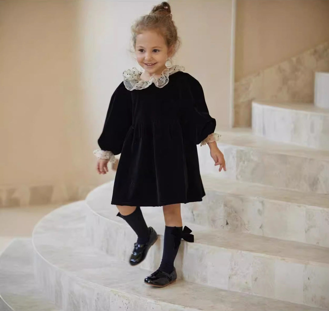 Smiling girl wearing black velvet long sleeve dress with polka dot collar – beekaaboo.com