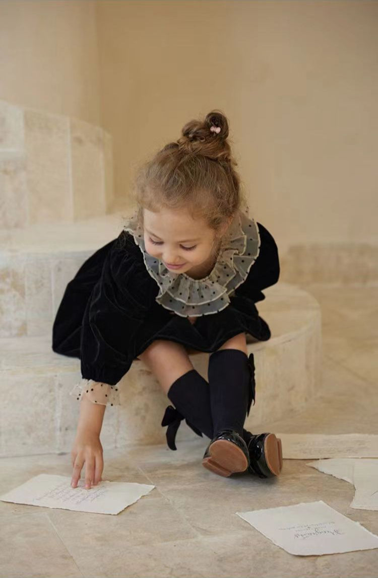 Baby girl styled in vintage black velvet dress