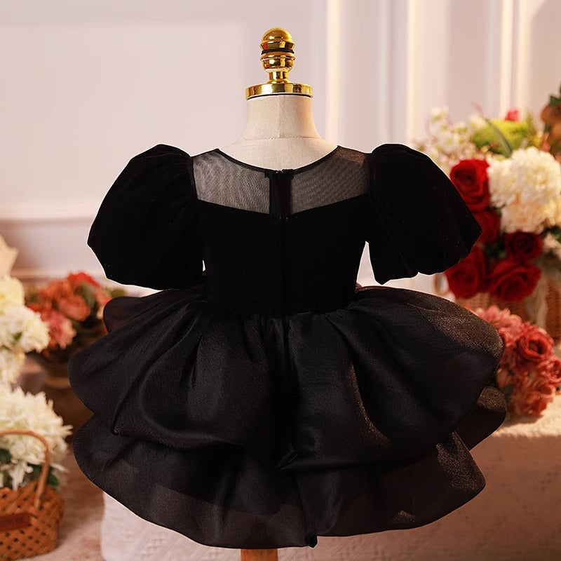 Back view of black puff sleeve princess dress with zipper and layered skirt – beekaaboo.com