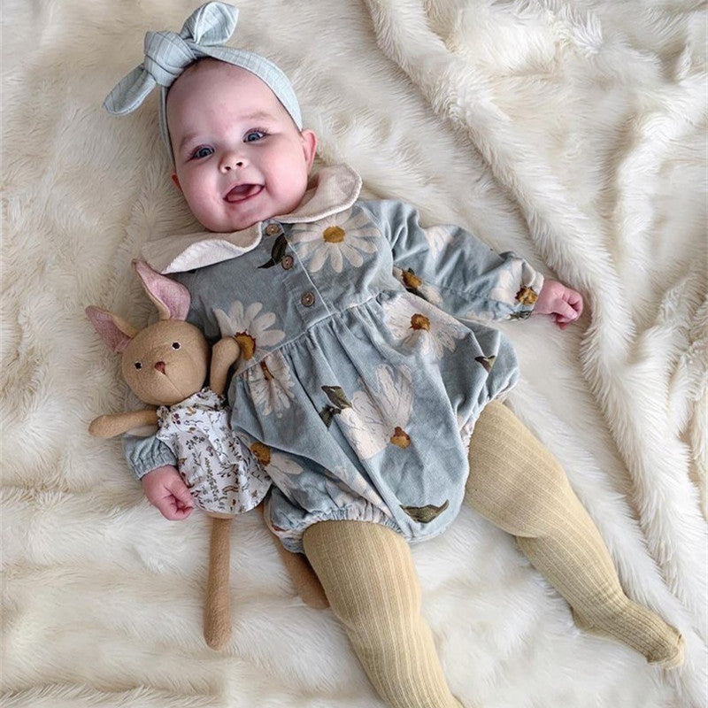Baby girl wearing blue corduroy romper with classic doll collar – cozy and stylish – beekaaboo.com
