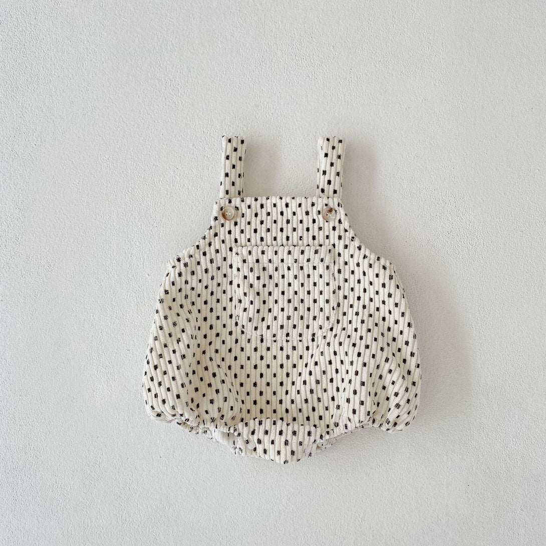 Flat lay display of checkered baby romper – soft cotton-poly blend – beekaaboo.com