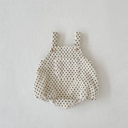 Flat lay display of checkered baby romper – soft cotton-poly blend – beekaaboo.com