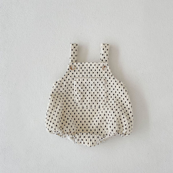 Flat lay display of checkered baby romper – soft cotton-poly blend – beekaaboo.com