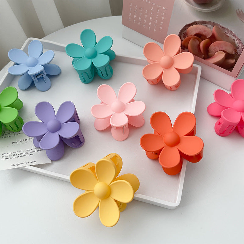 Display of all 30+ color variations of frosted flower hair clips in small and big sizes – soft matte finish – beekaaboo.com