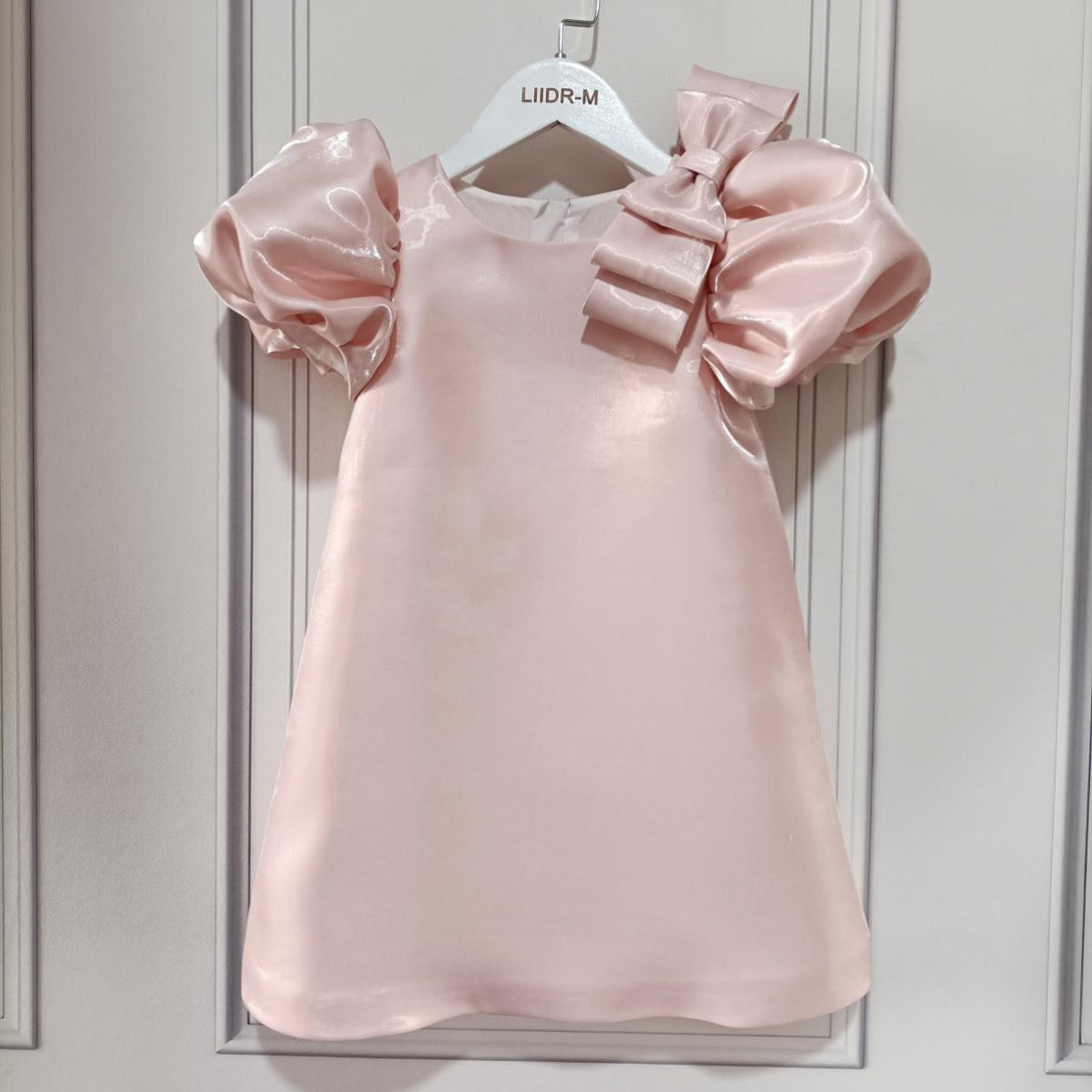 Front view of girls' elegant pink dress with bubble sleeves and flared design – beekaaboo.com