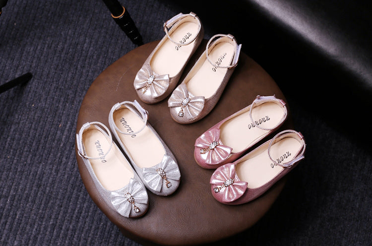 Display of glittery PU ballerina flats for girls in gold, pink, and silver, featuring sparkling bows and gemstone detail – beekaaboo.com