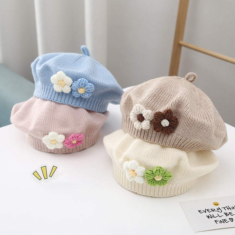 Toddler wearing white beret with flower detail – soft winter baby outfit – beekaaboo.com