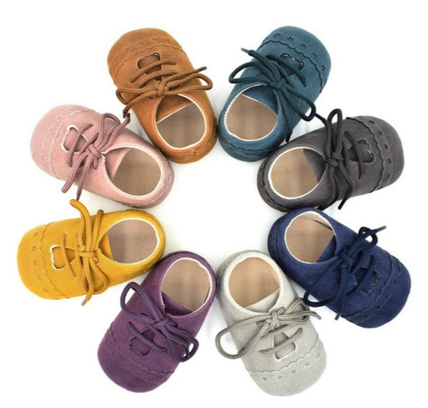 Full view of all available colors of lace-up soft sole baby shoes for toddlers 0–12 months. Soft rubber soles and unisex design—shop at beekaaboo.com.
