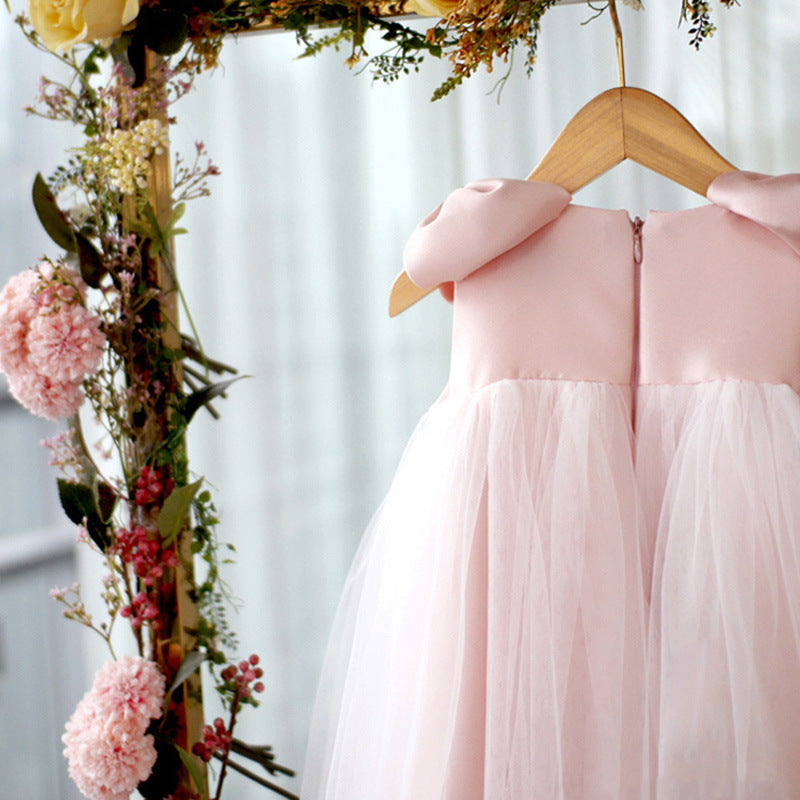 Close-up of the back details of pink princess dress showing zipper and bow shoulder accents – beekaaboo.com