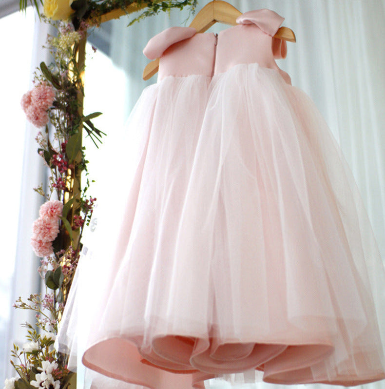 Lower back view of pink princess dress displaying full layered skirt and flowing hem – beekaaboo.com
