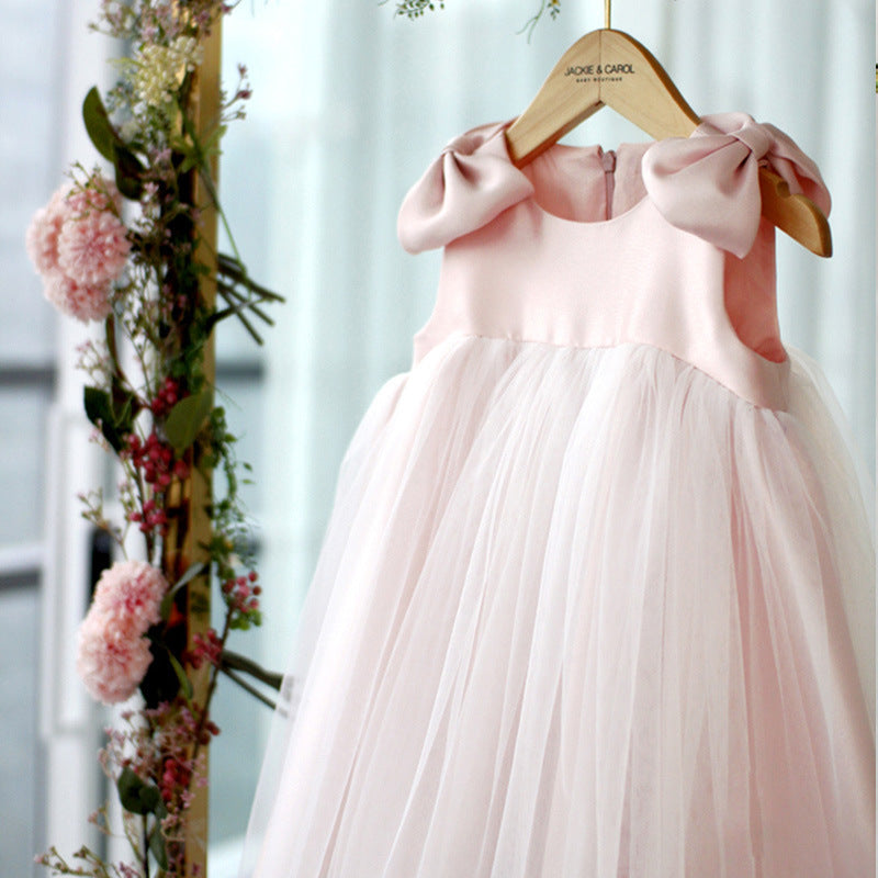 Close-up of pink princess dress front showing satin bodice, large bow shoulders, and layered tulle skirt – beekaaboo.com