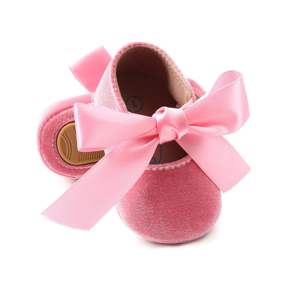 Adorable pink soft-soled toddler shoes with front ribbon ties, perfect for birthdays and photo shoots. Shop now at beekaaboo.com