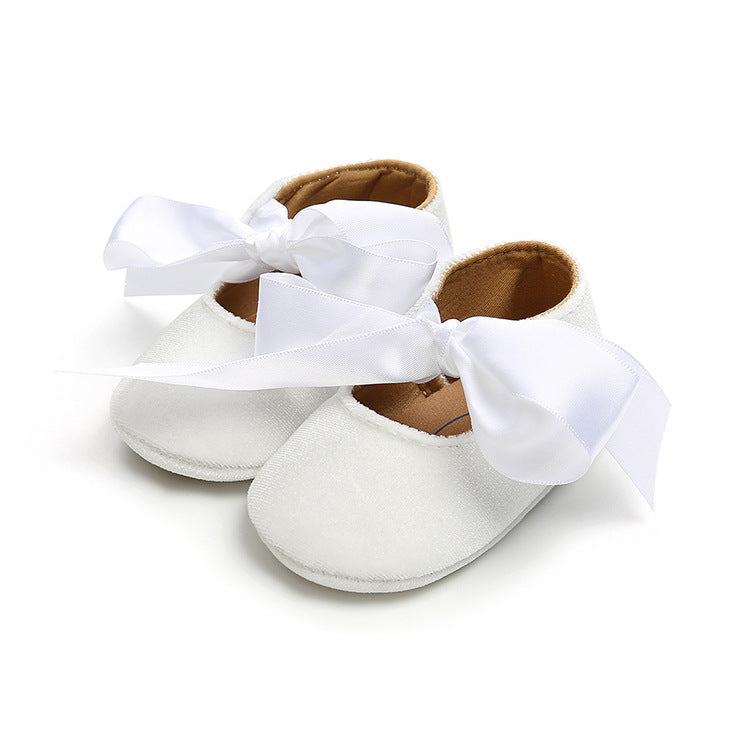 White ribbon-tied soft-soled baby princess shoes for girls, perfect for weddings, birthdays, and special occasions. Shop at beekaaboo.com.