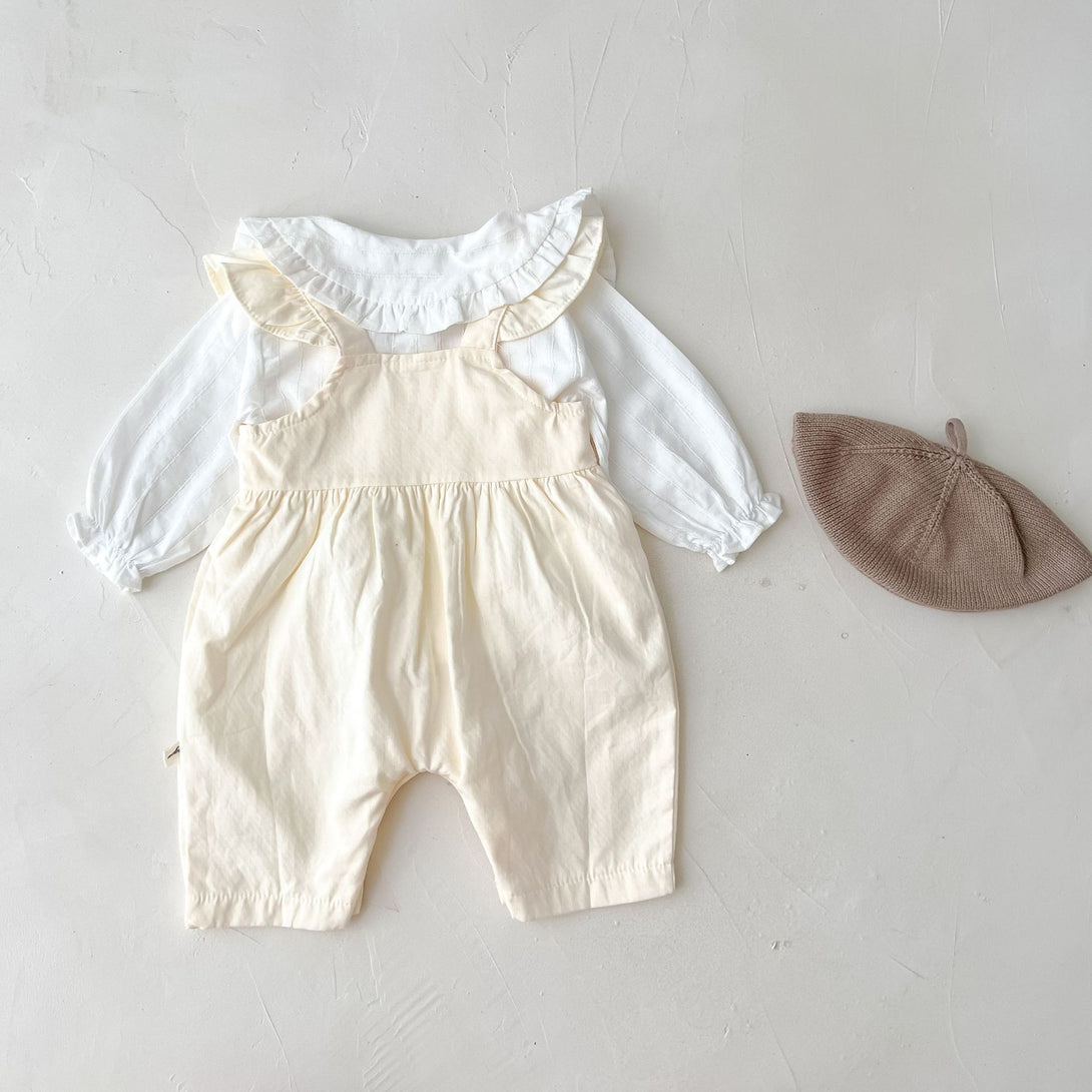 Back view of full baby girl outfit laid down – white shirt and apricot trousers – beekaaboo.com