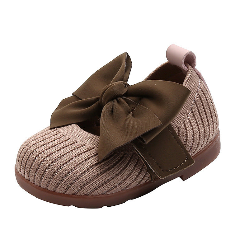Side view showing the elegant design of the soft leather shoes with Velcro strap for a perfect fit.
