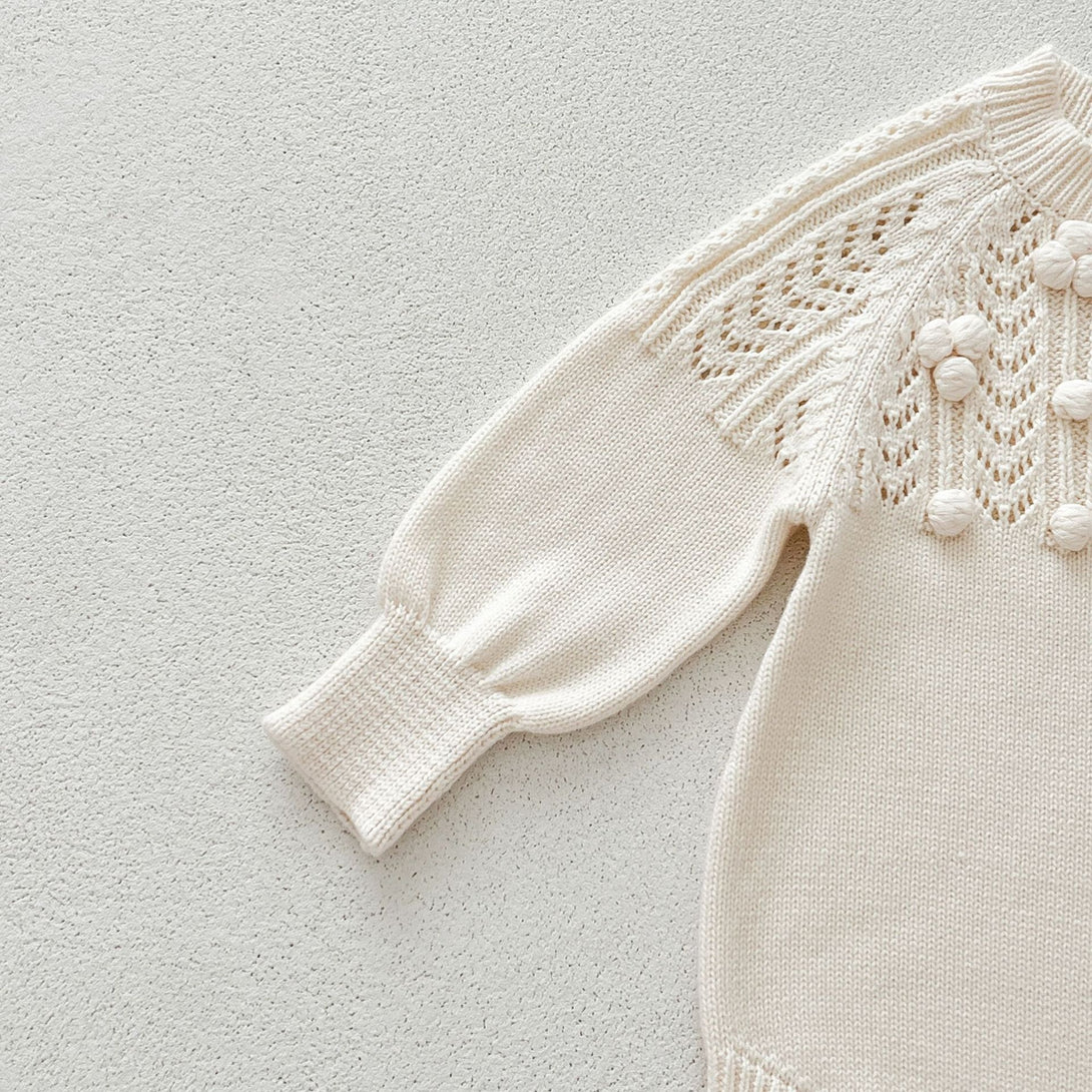 Close-up of Long-sleeve romper flat lay – ivory knit set – beekaaboo.com