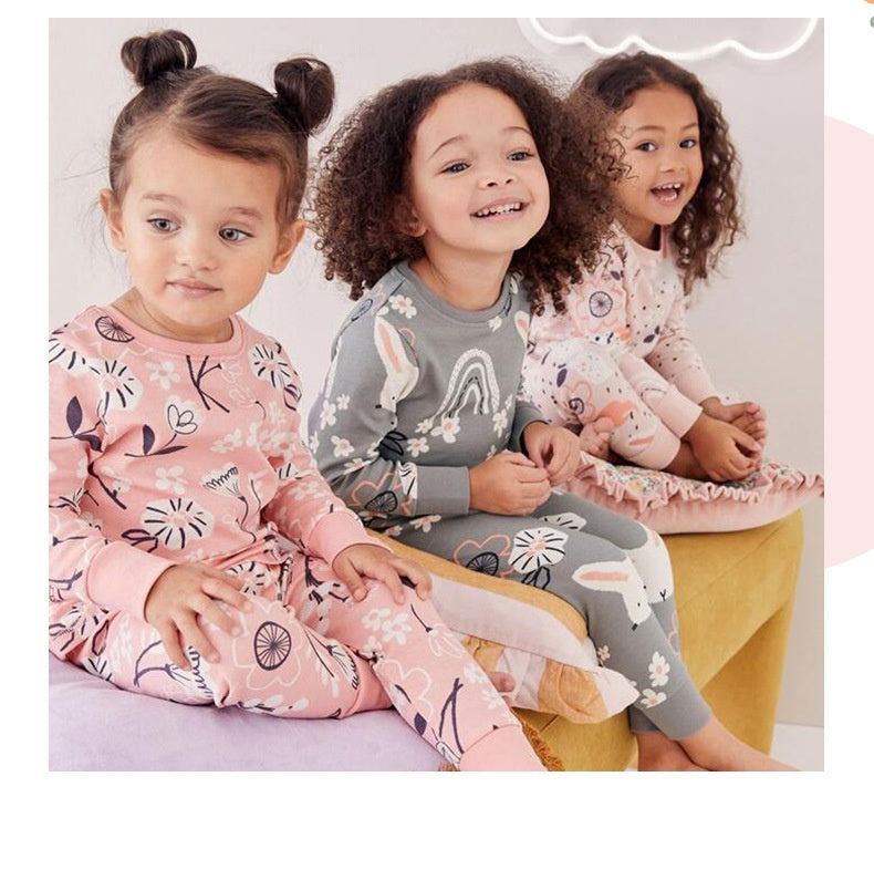 Three kids wearing matching floral and animal print cotton outfits – front view – beekaaboo.com