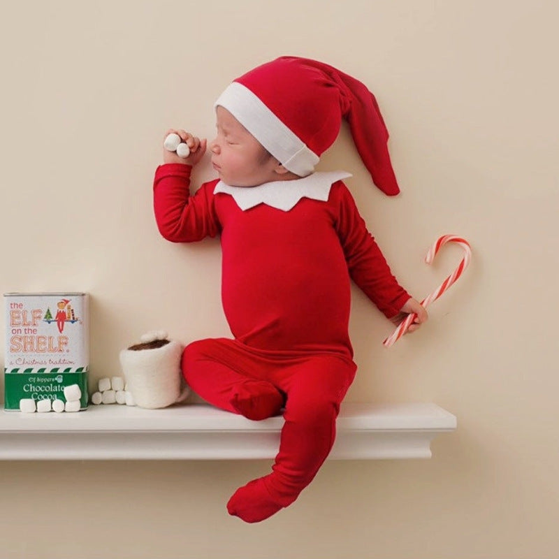 Adorable baby wearing red romper for Christmas photography | beekaaboo.com